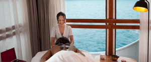 Onboard Activities: A woman is receiving a relaxing massage in a spa room