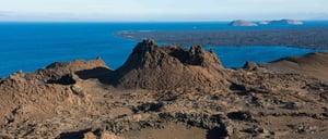 Bartolome in Galapagos Islands view of the volcanic terrain and the crater, with tourist taking pictures