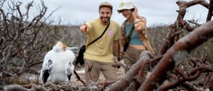 Photographer taking pictures of a Red footed booby on Genovesa Islands Galapagos