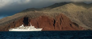 Rabida in Galapagos Islands, view of the red hill with tourist looking around