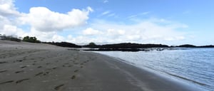 Cerro Brujo - San Cristobal in Galapagos Islands, view of the beach landscape with a blue sky