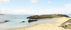 Cerro Brujo - San Cristobal in Galapagos Islands, view of the beach landscape with a blue sky