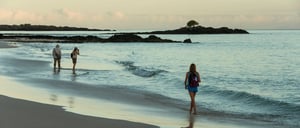 Bachas Beach - Santa Cruz in Galapagos Island beautiful white sand beach and tourist walking