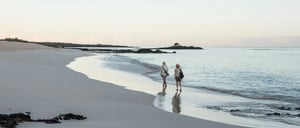 Bachas Beach - Santa Cruz in Galapagos Island beautiful white sand beach and tourist walking