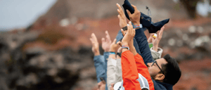 Travelers raising their hands at South Plaza Island