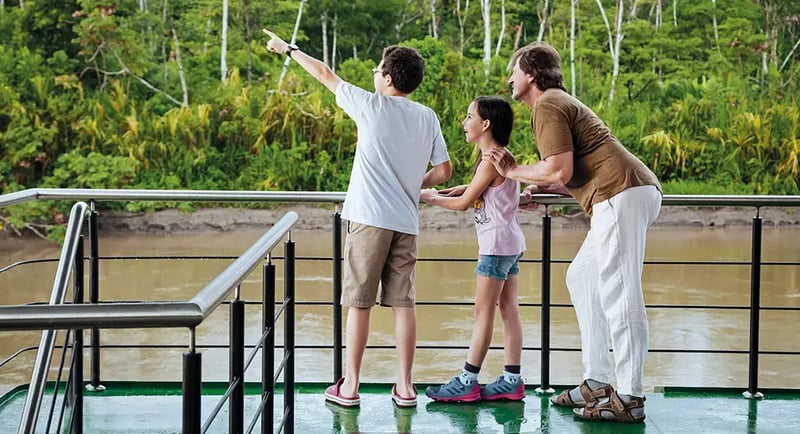 Family enjoys wildlife spotting from the Anakonda Amazon Cruise, exploring Ecuador’s rainforest
