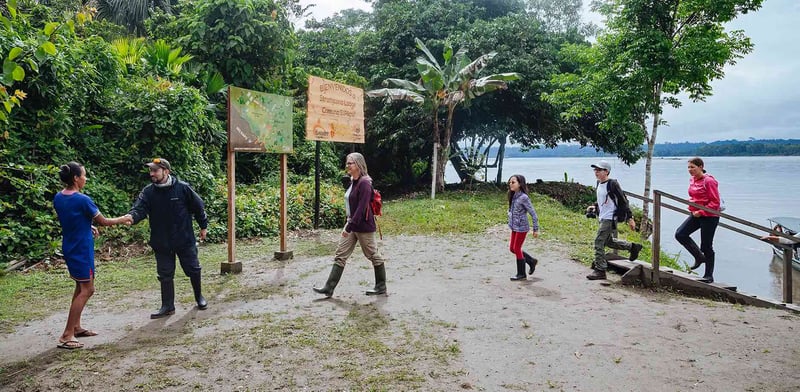 Cultural immersion in the Amazon! Travelers from the Anakonda Cruise visit an indigenous village for an authentic experience.